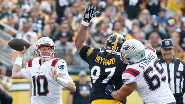 New England Patriots quarterback Mac Jones (10) passes against pressure from Pittsburgh Steelers defensive tackle Cameron Heyward (97) during the fourth quarter at Acrisure Stadium. The Patriots won 17-14.